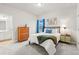 Bright bedroom featuring a comfortable bed, stylish furnishings, and a view from the window at 18267 W 95Th Ave, Arvada, CO 80007