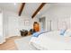 Large bedroom with beamed, vaulted ceiling, sitting area and wardrobe cabinet at 18267 W 95Th Ave, Arvada, CO 80007