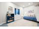 Cozy bedroom with a blue accent bookshelf and daybed at 18267 W 95Th Ave, Arvada, CO 80007
