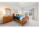 Cozy bedroom featuring a wood frame bed, carpeted floor, and neighborhood view at 18267 W 95Th Ave, Arvada, CO 80007