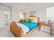 Comfortable bedroom featuring wood bed frame, ensuite bathroom, and large window with sunset views at 18267 W 95Th Ave, Arvada, CO 80007