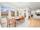 Sunlit dining room with wood table, seating for six, and large windows with scenic views at 18267 W 95Th Ave, Arvada, CO 80007
