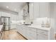 Contemporary kitchen featuring white cabinets, quartz countertops, and stainless steel appliances at 18267 W 95Th Ave, Arvada, CO 80007