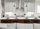 Modern kitchen island with seating, pendant lighting, and open view to the living area at 18267 W 95Th Ave, Arvada, CO 80007