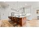 Modern kitchen featuring an island with bar seating, stainless steel appliances, and white cabinets and countertops at 18267 W 95Th Ave, Arvada, CO 80007