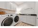 Well-equipped laundry room with modern appliances, storage cabinets, and stylish countertops at 18267 W 95Th Ave, Arvada, CO 80007