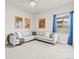 Comfortable living room with a large sectional sofa, bright window, and fun comic book art at 18267 W 95Th Ave, Arvada, CO 80007