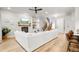 Comfortable living room showcases hardwood floors, fireplace, and a large sectional couch with staircase in the background at 18267 W 95Th Ave, Arvada, CO 80007