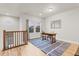 Bright office space with a large window, wood desk, and blue and white striped rug at 18267 W 95Th Ave, Arvada, CO 80007