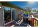 Back deck with patio table and grill, accessible through sliding glass door at 201 S Monmouth Ave, Firestone, CO 80520