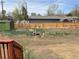 Large backyard with a wood fence and partially cleared ground at 201 S Monmouth Ave, Firestone, CO 80520