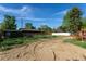 Spacious backyard with storage shed, a privacy fence and wood stairs to the back deck at 201 S Monmouth Ave, Firestone, CO 80520