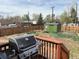Backyard with a grill on the deck and a small storage shed in the fenced-in yard at 201 S Monmouth Ave, Firestone, CO 80520