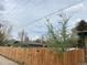 A wooden fence surrounds a backyard with a small tree and other vegetation at 201 S Monmouth Ave, Firestone, CO 80520