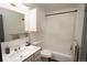Bathroom featuring a vanity, mirror, overhead cabinet, and a shower with a white curtain at 201 S Monmouth Ave, Firestone, CO 80520