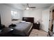 Bedroom with a queen bed, a dark wooden dresser and a nightstand with a lamp at 201 S Monmouth Ave, Firestone, CO 80520