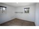 Vacant bedroom with neutral walls and carpet, featuring two windows for natural light at 201 S Monmouth Ave, Firestone, CO 80520