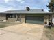 Ranch style home featuring a green garage door and a driveway with space for parking at 201 S Monmouth Ave, Firestone, CO 80520