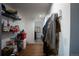 Hallway with wood floors, storage and access to additional rooms and utilities at 201 S Monmouth Ave, Firestone, CO 80520