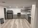Bright kitchen featuring stainless appliances, gray cabinets and shelving at 201 S Monmouth Ave, Firestone, CO 80520