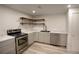 Updated kitchen featuring stainless steel appliances, gray cabinets, and modern countertops at 201 S Monmouth Ave, Firestone, CO 80520