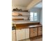 Butcher block counters and floating shelves add warmth and storage to this kitchen at 201 S Monmouth Ave, Firestone, CO 80520