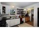 A kitchen with tiled floors, white cabinetry and backsplash, and wooden countertops at 201 S Monmouth Ave, Firestone, CO 80520