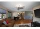 Cozy living room with wood floors, a plush rug, comfortable seating, and a modern ceiling fan at 201 S Monmouth Ave, Firestone, CO 80520