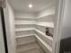 Walk-in pantry with white shelves for optimal storage at 201 S Monmouth Ave, Firestone, CO 80520