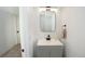 Powder room featuring modern fixtures, a sleek mirror, and a vanity with storage at 201 S Monmouth Ave, Firestone, CO 80520