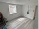 Room featuring wood-look flooring and a window at 201 S Monmouth Ave, Firestone, CO 80520