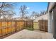 Fenced backyard with a concrete patio and grassy area at 14192 E Baltic Pl, Aurora, CO 80014
