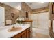 Traditional bathroom boasts an updated sink, decorative wallpaper and shower/tub combination at 14192 E Baltic Pl, Aurora, CO 80014