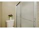 Close-up of a bathroom shower and toilet area, decorated with wallpaper and flowers at 14192 E Baltic Pl, Aurora, CO 80014
