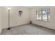 Well-lit bedroom featuring a large window, soft carpet, and neutral wall color at 14192 E Baltic Pl, Aurora, CO 80014