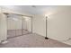 Bedroom with neutral carpet, large mirrored closet and classic stand lamp at 14192 E Baltic Pl, Aurora, CO 80014