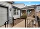 Charming home exterior with gray siding, brick accents, walkway, and inviting covered front porch at 14192 E Baltic Pl, Aurora, CO 80014