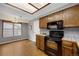 Cozy kitchen with wood cabinets, black appliances, and a bright window overlooking the exterior at 14192 E Baltic Pl, Aurora, CO 80014