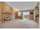 Bright living room showcasing a brick fireplace, sliding glass door access, and ample natural light at 14192 E Baltic Pl, Aurora, CO 80014