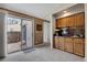 Inviting living room with sliding doors to patio, a wet bar, and neutral carpeting at 14192 E Baltic Pl, Aurora, CO 80014