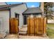Private backyard patio with wood fence and sliding glass door access to the home interior at 14192 E Baltic Pl, Aurora, CO 80014