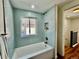 Bathroom showcasing stylish blue tile, a soaking tub, and modern fixtures for a spa-like experience at 601 W Layton Ave, Englewood, CO 80110
