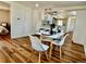 Open dining area adjacent to the kitchen, featuring modern table and chairs and wood flooring at 601 W Layton Ave, Englewood, CO 80110