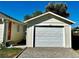 Detached garage with white door, offering ample parking and storage space at 601 W Layton Ave, Englewood, CO 80110