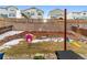 A multi-level backyard with a retaining wall, playhouse, a slide, a windmill and grass at 1262 High Point Trl, Elizabeth, CO 80107