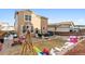 An expansive backyard with a patio, playground, windmill, and a two-story house at 1262 High Point Trl, Elizabeth, CO 80107