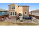 The backyard has an outdoor seating area, grill, and a wooden fence surrounding the property at 1262 High Point Trl, Elizabeth, CO 80107