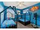 Blue themed bedroom with two beds and lots of natural light at 1262 High Point Trl, Elizabeth, CO 80107