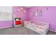 Bright bedroom featuring a toddler bed, plush decor, and playful wall decorations at 1262 High Point Trl, Elizabeth, CO 80107