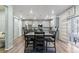 Well-lit dining room with stainless appliances, a barn door, and modern stylish décor at 1262 High Point Trl, Elizabeth, CO 80107